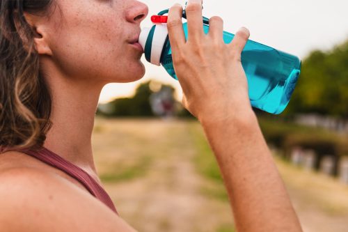 woman-athlete-drinking-water-exercising-1296x728-header